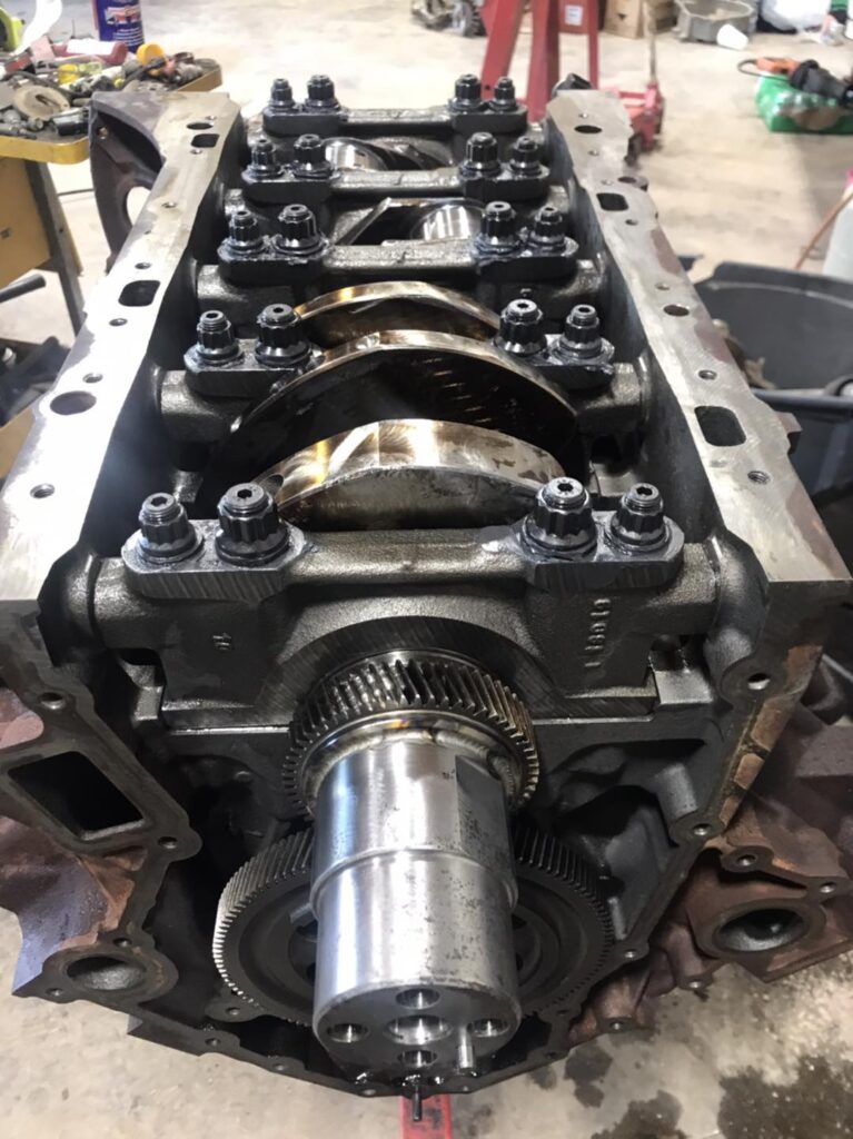 Diesel engine crankshaft and rotating assembly exposed during engine teardown at Say When Motorsports