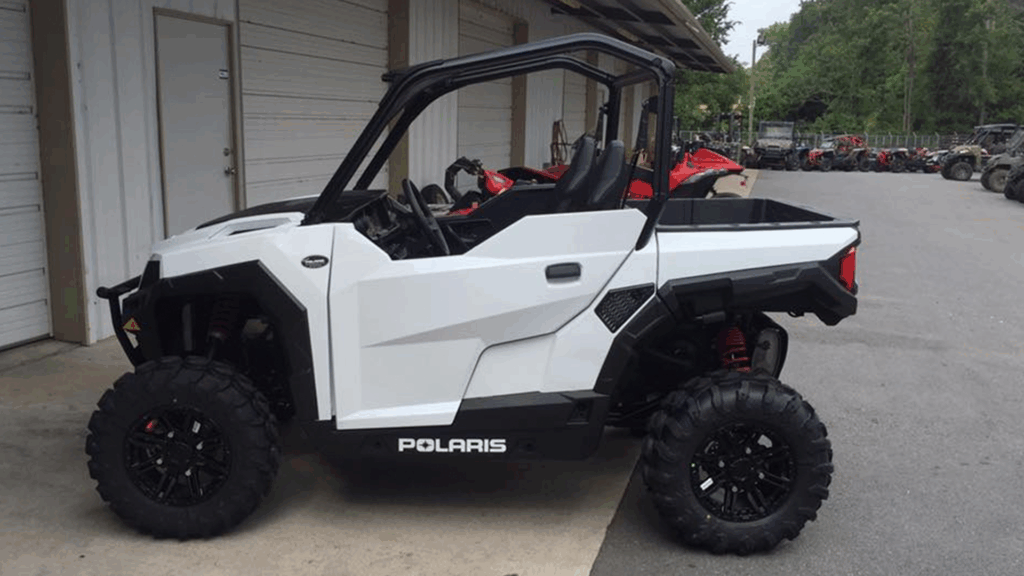 White Polaris side-by-side UTV with oversized off-road tires and suspension parked outside Say When Motorsports in Cabot Arkansas